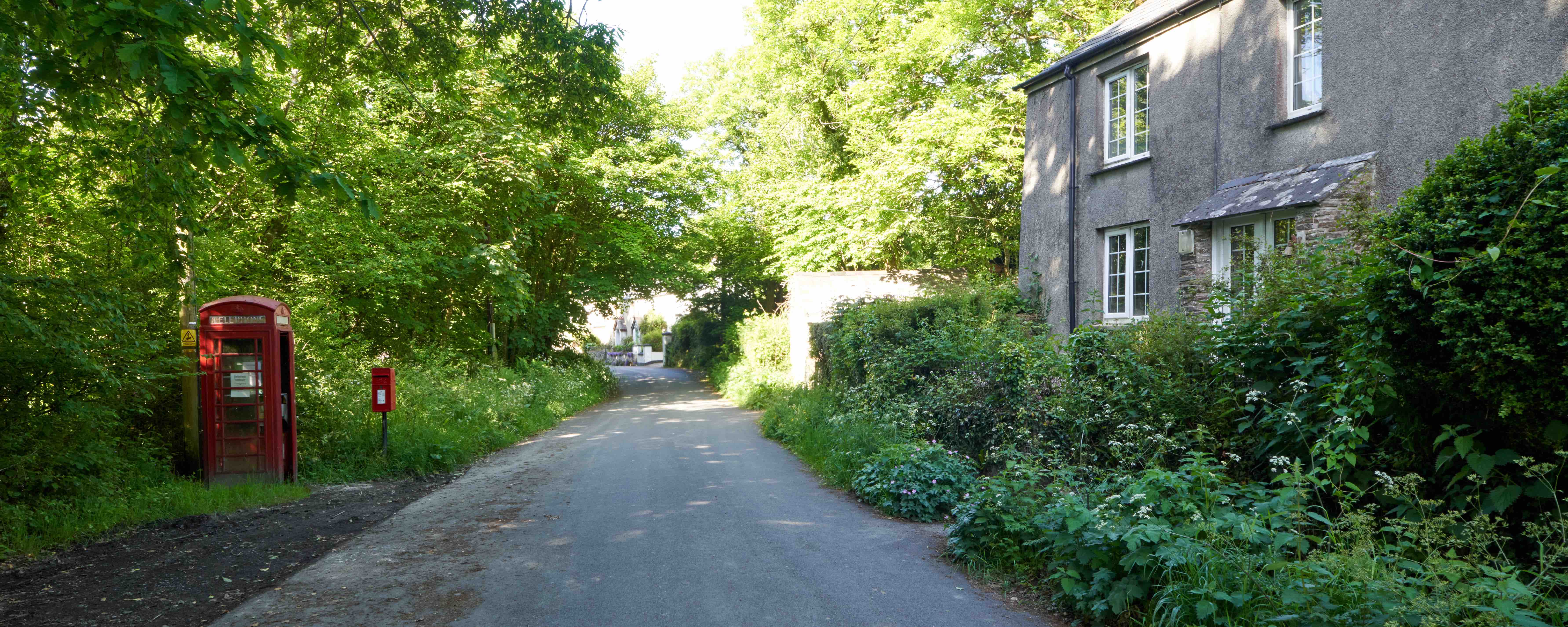 Photo of lane with red phone box